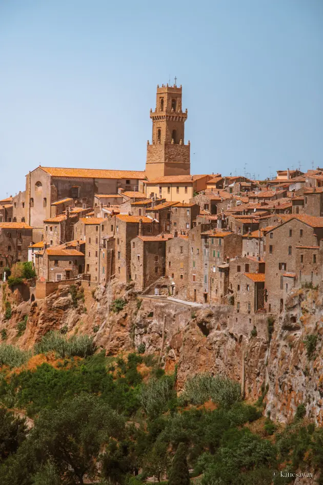 the etruscan hilltop city of pitigliano in italy with houses carved into the cliff face