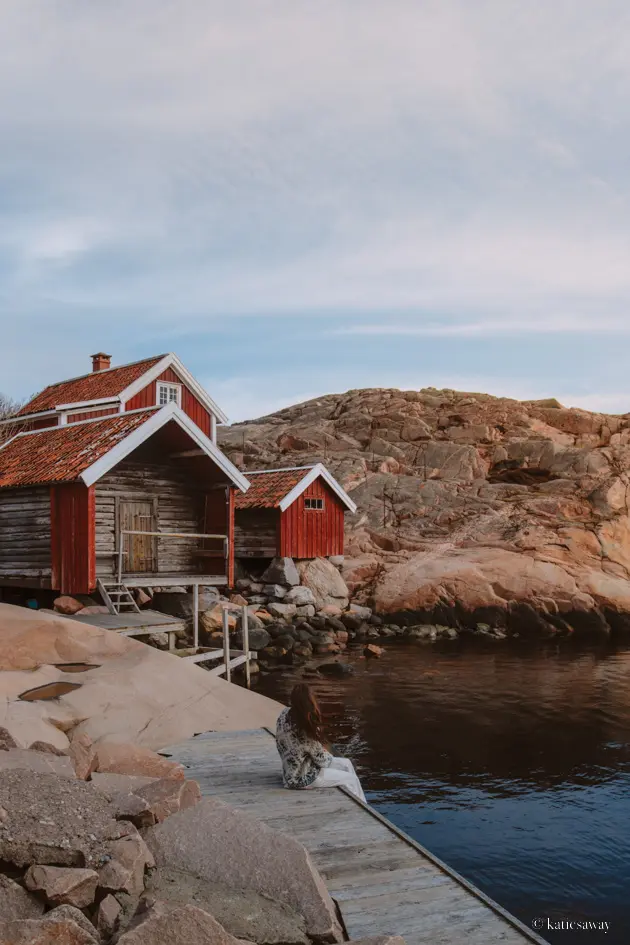 A collection of red boat houses part of the Vikarvet Culture Reserve